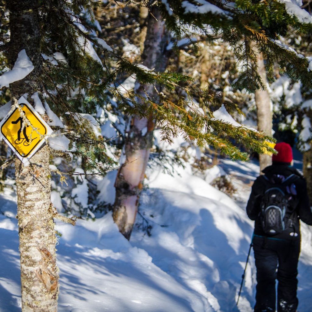 Snowshoeing with sign