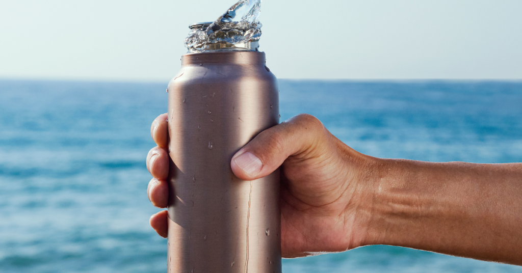 Reusable water bottle in front of lake