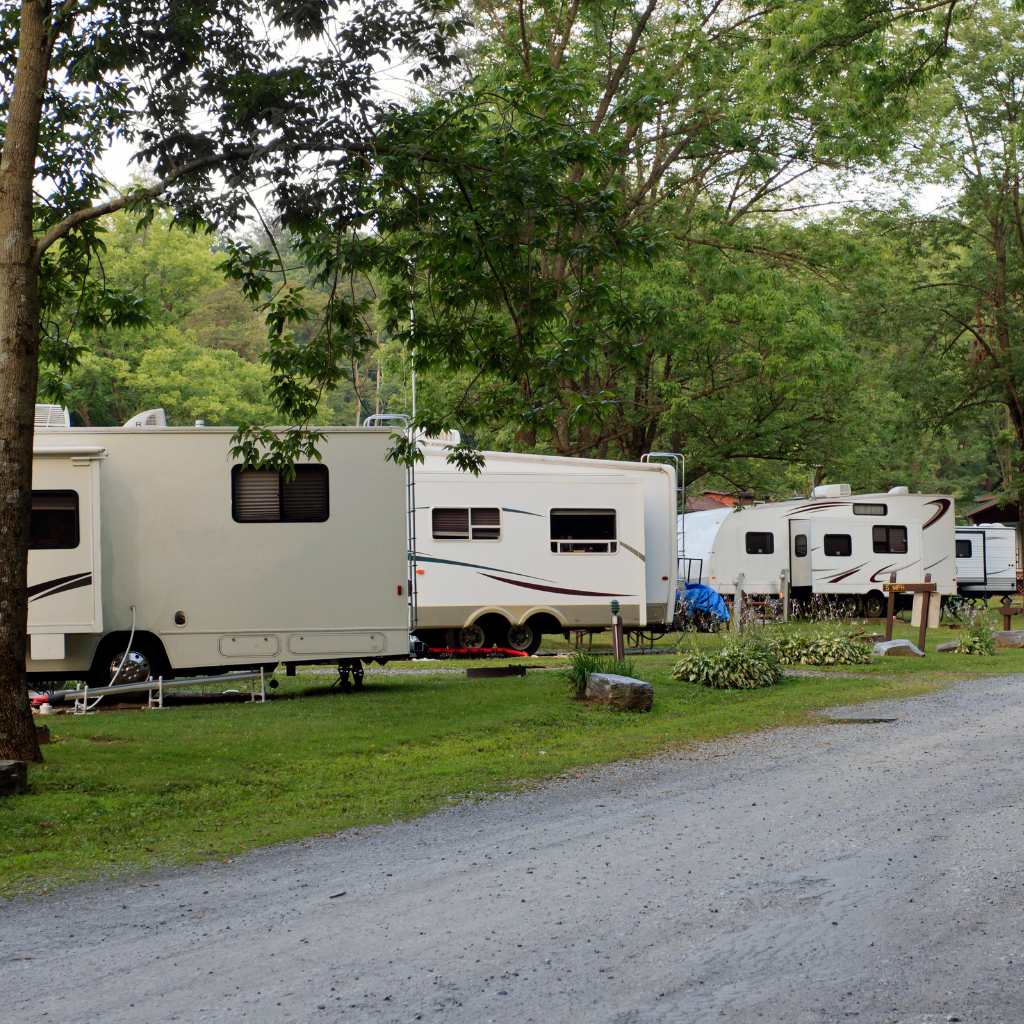 Photo of 4 different campers set up at a campground