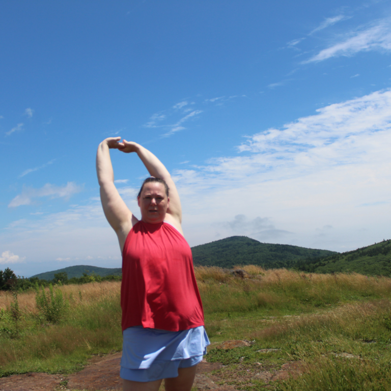 The Fat Girl Hiking At The Summit Of A Mountain With Mountain Background Wearing A Hiking Skirt