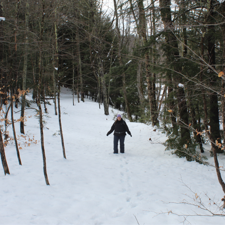 On the hiking trail in a heated jacket in winter