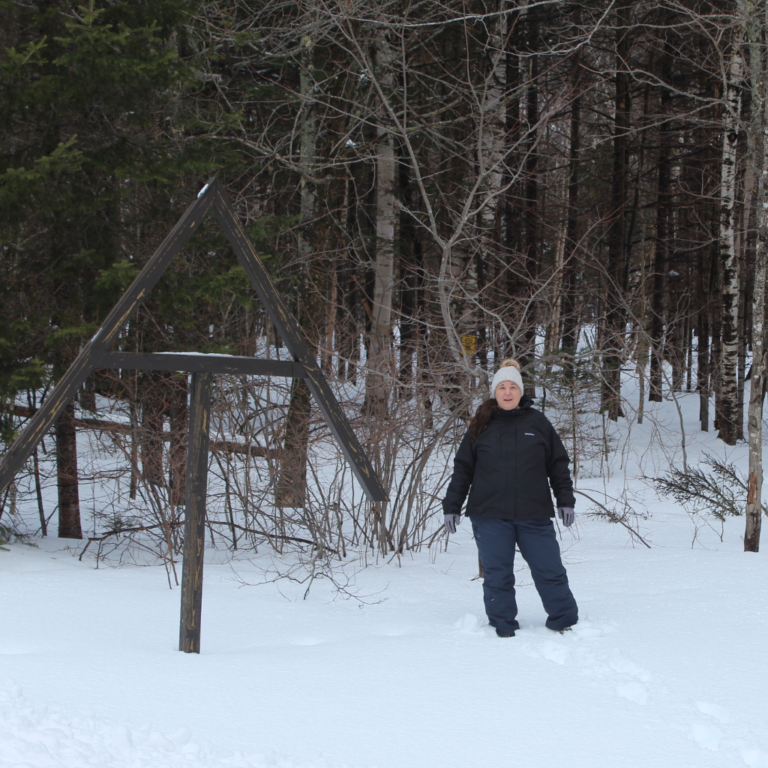 The Fat Girl Hiking wearing a black 3 in 1 winter hiking jacket at the start of a section of the Appalachian trail in Maine in winter