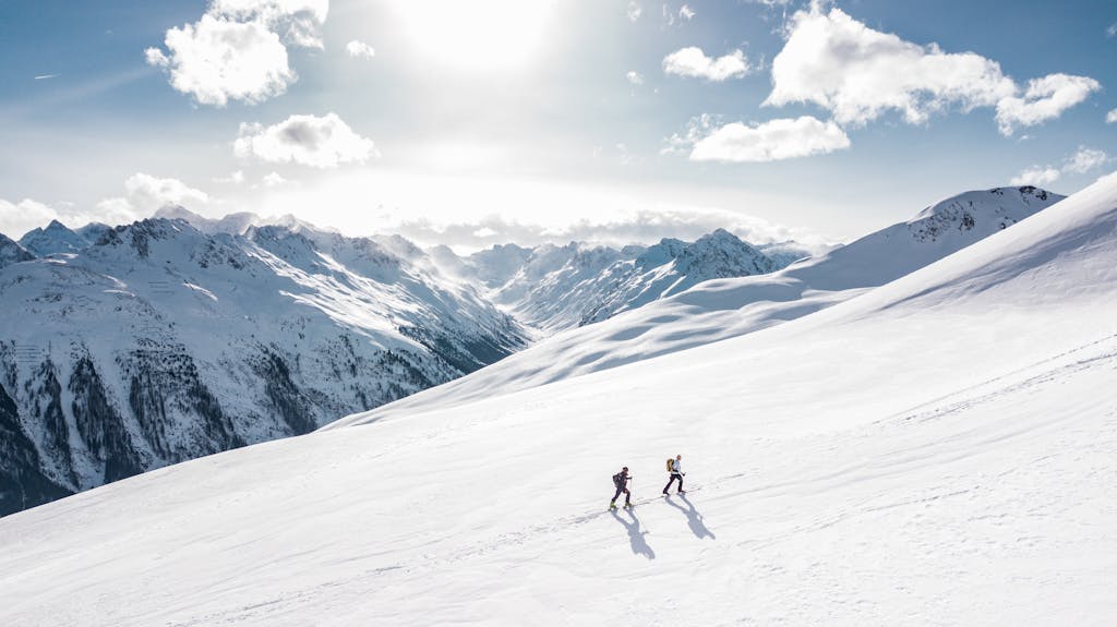 Two People Hiking on a Snowy Mountain